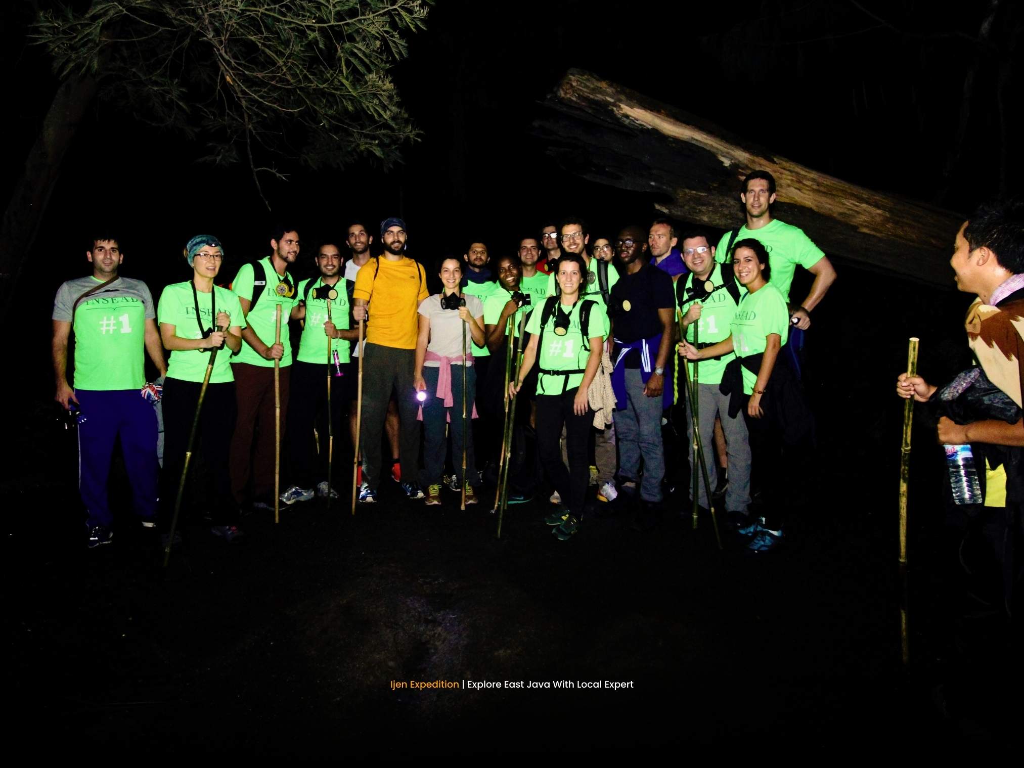Hikers ascending Mount Ijen at night with headlamps