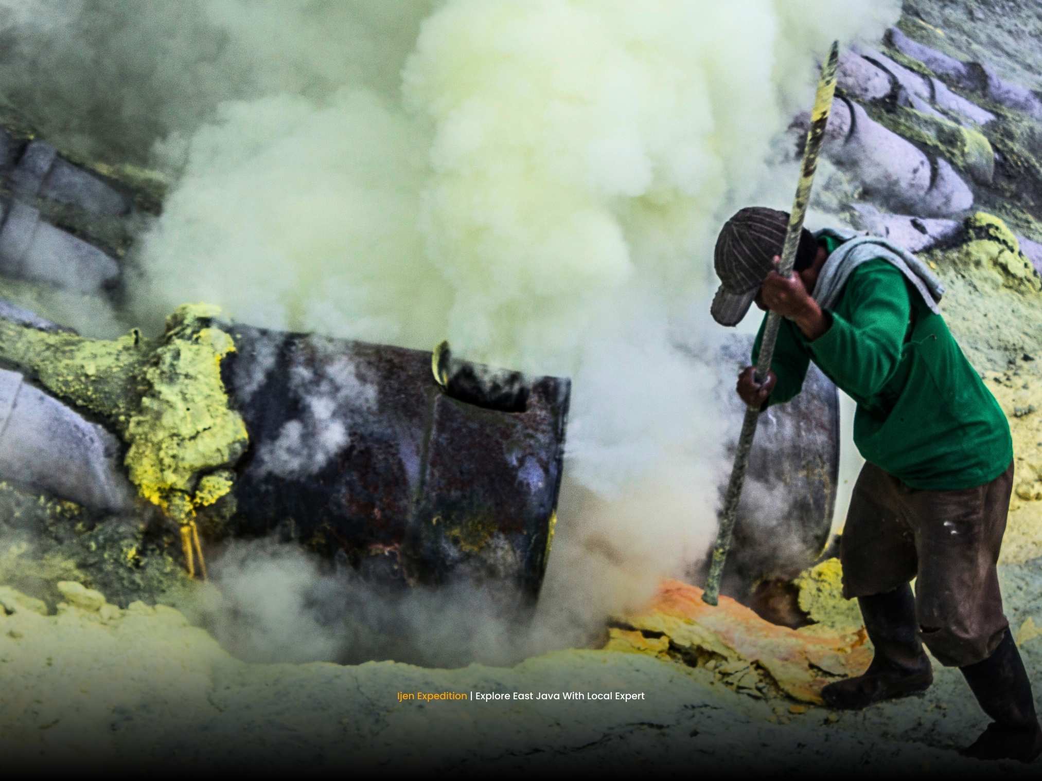 Sulfur miners carrying heavy baskets inside Ijen crater