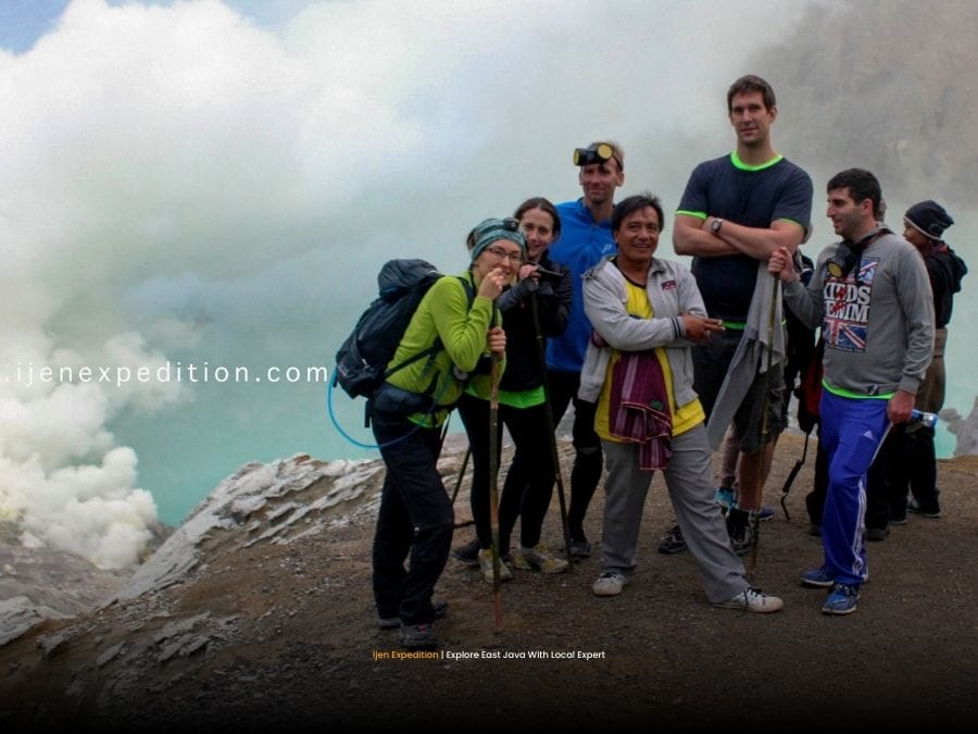 Licensed local guide assisting tourists during Ijen volcano night hike