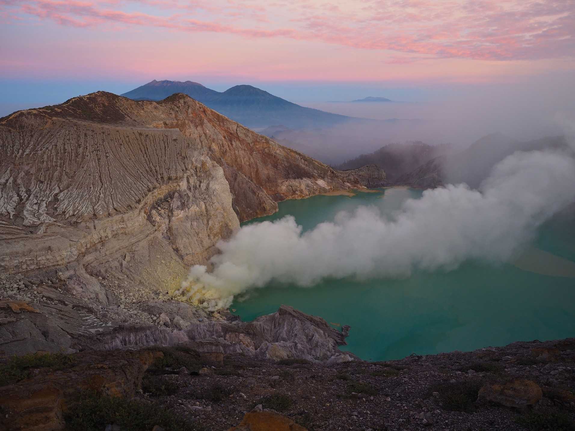 Ijen Volcano Tour from Bali sunrise view over acidic crater lake
