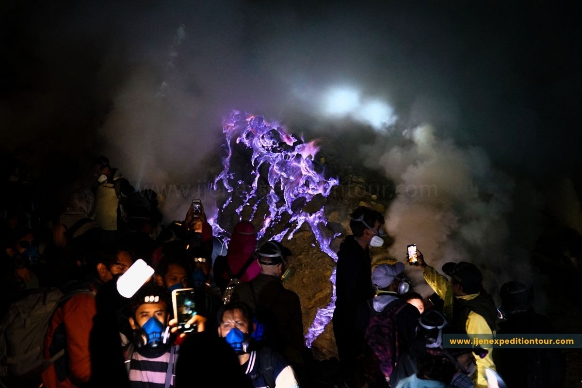 blue fire flames lighting the volcanic landscape at night