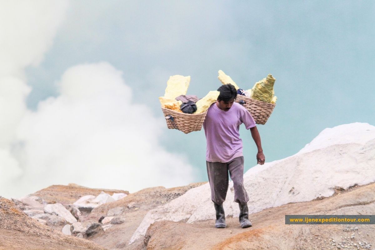 sulfur miners carrying baskets at Ijen crater Indonesia